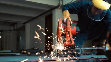 Profesyonel tamirci çelik metali dönen elmas kesici ile kesiyor. Çelik endüstrisi ve atölye konsepti.