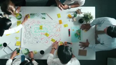 Profesyonel iş adamlarının zihin haritasını kullanarak beyin fırtınası yapmak için birlikte çalıştıklarına dair üst düzey bir görüş. Akıllı yöneticilerin sürdürülebilir enerji hakkında konuştuğu ve tartıştığı hava görüntüsü. Hizalama.