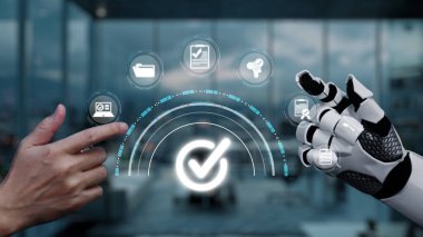 Bir insan eli robot eliyle etkileşime girer, veri yönetiminde kusursuz bir bağlantı sergiler, modern çalışma alanındaki teknoloji ve işbirliğindeki yenilikleri ön plana çıkarır. Auvana