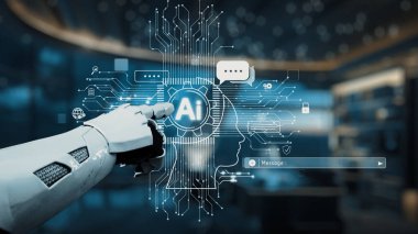 Robot bir el, modern bir çalışma alanındaki teknoloji ve yeniliğin kesişimini sembolize eden yapay zekanın dijital temsiline uzanıyor. Auvana