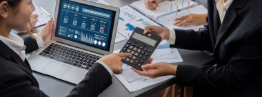 İş zekası ve veri analizi kavramı. Analizci ekibi laptop ekranında finansal veri analizi üzerinde çalışıyor. Etkili iş stratejik planlama için pazarlama göstergesi olarak. İçgörü