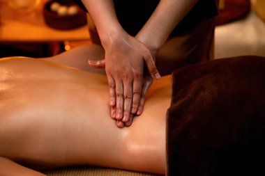 Yakından kadın müşteri strese karşı spa masajını rahatlatıyor ve lüks otel ya da otelde sıcak mum ışığında güzellik teniyle eğleniyor. Sessiz.