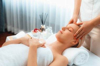 Kafkasyalı kadın stres önleyici kafa masajından ve lüks tatil beldesi ya da otel spa salonundaki modern ışık ortamında yüz güzelliği eğlencelerini şımartmaktan hoşlanıyor. Sessiz.