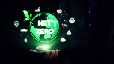 Net sıfır emisyonlarının görsel bir temsili. Bir elde parlayan bir küre içeriyor. Sürdürülebilirlik ve daha sağlıklı bir gezegende teknolojik rolü sembolize eder. Dörtgen