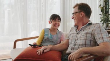 Büyükbaba ve torun birlikte TV 'de ilginç bir eğlence medyası izliyorlar. Eski üst düzey kullanım teknolojisi, genç nesil çapraz nesil ile iletişim kurarak aile bağlarını güçlendiriyor. Uyumsuzluk.