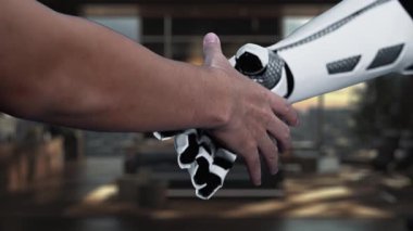 İnsan eliyle robot el arasındaki etkileşimi tasvir eden, modern ofis ortamındaki bulut depolama kavramlarını gösteren fütüristik bir sahne. Auvana