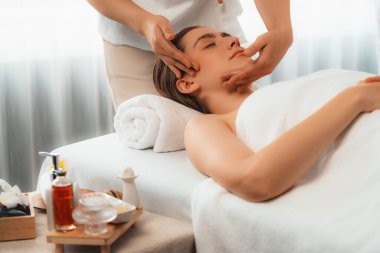 Kafkasyalı kadın stres önleyici kafa masajından ve lüks tatil beldesi ya da otel spa salonundaki modern ışık ortamında yüz güzelliği eğlencelerini şımartmaktan hoşlanıyor. Sessiz.