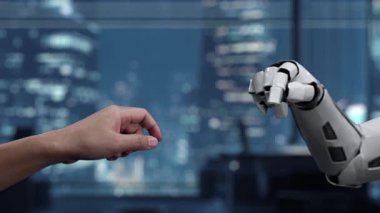 Parlak bir ofis alanında robot kola uzanan bir insan elinin çarpıcı tasviri, dijital çağda insanlar ve makineler arasındaki ileri etkileşimi sembolize ediyor. Auvana