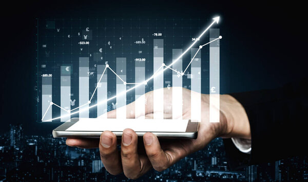 A close-up view of a hand holding a smartphone displaying a financial chart with upward growth, symbolizing investment success and data analysis. Impute