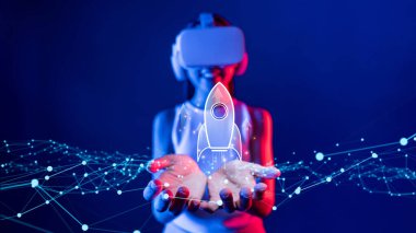 Sanal gerçeklik kulaklığı takan bir kadın, teknoloji odaklı bir dünyada yeni iş ve yenilikçi girişimlerin başladığını simgeleyen parıldayan dijital bir roket taşıyor. XDMCP