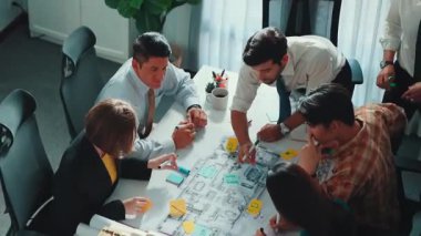 Proje planıyla masaya otururken bir grup farklı takım planlama stratejisi. Zeki iş adamlarının beyin fırtınası ve ev yapımı için birlikte çalıştıklarının en üst düzey görüntüsü. Hizalama.