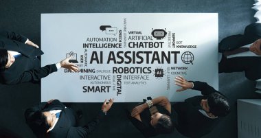 Modern bir iş ekibi, gelecekte yapılacak gelişmeler için işbirliğini ve stratejik planlamayı vurgulayarak, parlak bir çalışma alanında yenilikçi yapay zeka yardımcı teknolojilerini tartışıyor. Dostluk