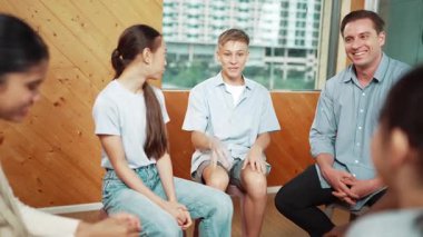 Enerjik çocuk grup terapisinde günlük kıyafet deneyimini paylaşırken gülüyor. Kafkas öğretmeni ve çeşitli çocuklarla dolu bir lise öğrencisi zihinsel sağlıktan bahsediyor. Öğretim