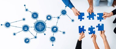 This image showcases a collaborative effort in a modern business environment where teams assemble puzzle pieces symbolizing creativity and connection around a digital network. Amity