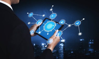 A business professional engages with a tablet displaying digital data visualization, showcasing connections in an urban landscape, symbolizing innovation and technology. Tessel