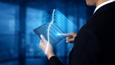 A business professional engages with a tablet to analyze data trends, surrounded by abstract digital graphics on a blue background, showcasing technology impact. Impute