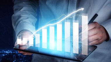 A professional setting featuring hands holding a digital tablet displaying a graph with upward trends, symbolizing business growth, financial success, and strategic planning in modern commerce. Copula