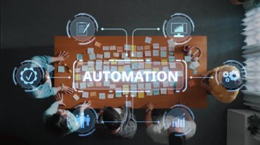A top-down view shows a team engaged in an automation strategy session using sticky notes, charts, and digital icons that enhance collaborative efforts in a modern office setting. Raster