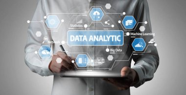 A professional in a white shirt interacts with tablet graphics showcasing data analytics for business intelligence. Ideal for technology and innovation themes. Tessel