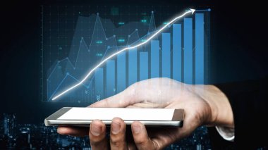 A hand holds a smartphone displaying a financial growth chart, illustrating advanced data visualization and the impact of technology on modern business strategies. Copula