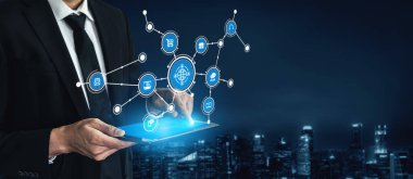 A business professional engages with a digital tablet, interacting with floating network icons against a city backdrop, showcasing modern technology and connectivity. Tessel