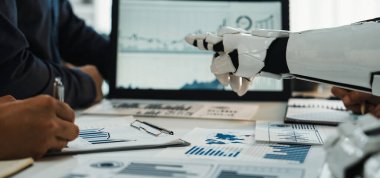 A futuristic robot arm collaborates with human professionals, analyzing data and providing insights in a modern office setting, emphasizing technology in business environments.Noogenesis