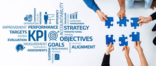 A diverse team collaborates by connecting puzzle pieces, representing key performance indicators and objectives essential for business strategy, management, and accountability. Amity