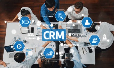 A dynamic business meeting showcasing a collaborative environment. Professionals engage in discussions around CRM concepts, emphasizing customer service and management strategies. Amity