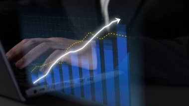 A business individual uses a laptop to evaluate data trends and performance metrics, showcasing a graph that indicates growth and positive projections in a corporate setting. Copula