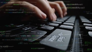 This image captures a close-up view of hands typing code on a sleek keyboard. Digital elements and binary effects create a modern technology theme perfect for programming projects. Xenic