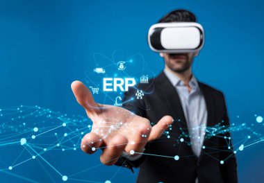 A business professional wearing virtual reality headset demonstrates ERP solutions in a digital environment, showcasing innovation in enterprise resource planning technologies. XDMCP