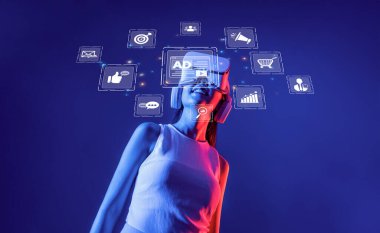 A young woman enjoys an immersive experience with a virtual reality headset while exploring digital marketing icons, illustrating the integration of technology and online ads. XDMCP