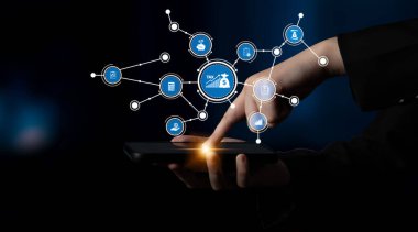 A close-up of a hand interacting with a tablet, featuring digital icons related to tax and financial services. This image captures modern technology in a business context. Tessel