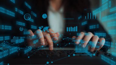 A business professional interacts with a laptop, surrounded by digital graphs and data, representing modern technology and data analysis in the financial sector. Xenic