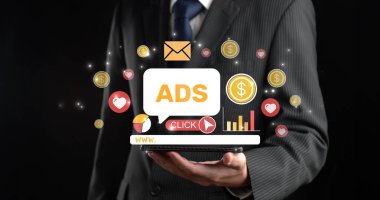 A businessman presents a digital tablet displaying various marketing icons and ads, symbolizing the dynamic world of online advertising and digital engagement strategies. XDMCP