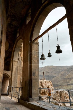 Photo for Bells in the arch of the mountain temple. - Royalty Free Image