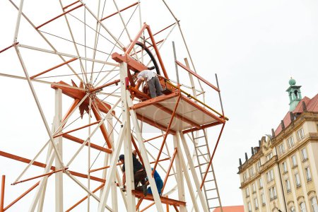 Photo for Workers dismantle the metal construction of the Ferris wheel in the city. Dresden, Germany - 05.20.2019 - Royalty Free Image