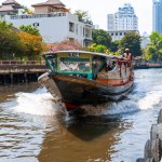 Boat cruising along the water channels of Bangkok. Public water transport. Bangkok, Thailand - 02.06.2020