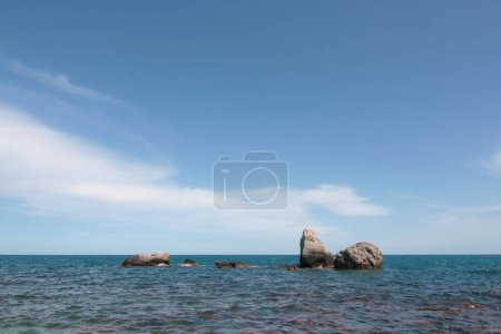 Photo for A rocky seashore with large stones in the water. - Royalty Free Image