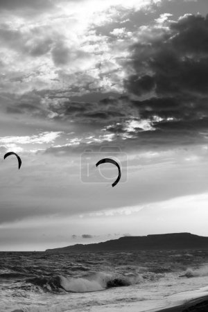 Photo for Two silhouette of power kites at sunset sky. Black and white toned landscape. High contrast. - Royalty Free Image