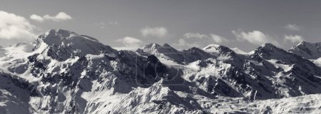 Panoramic view on snowy mountains in nice sunny evening. Caucasus Mountains. Svaneti region of Georgia at winter. Black and white retro toned landscape.