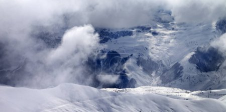 Photo for Snowy off-piste slope in sunlight clouds. Caucasus Mountains at winter, Georgia, region Gudauri. Panoramic view. - Royalty Free Image