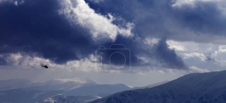 Foto de Panoramic view on helicopter in snowy winter mountains and cloudy sky. Caucasus Mountains, Georgia, region Gudauri. - Imagen libre de derechos