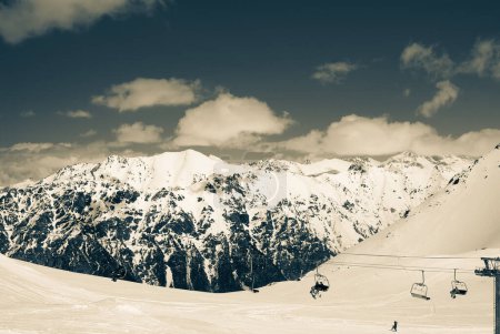 Foto de Ropeway at ski resort. Caucasus Mountains at snow winter, region Dombay. Retro color toned landscape. - Imagen libre de derechos