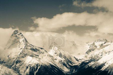 Foto de High winter snowy mountains. Caucasus Mountains, region Dombay, Mount Belalakaya. Retro color toned landscape. - Imagen libre de derechos
