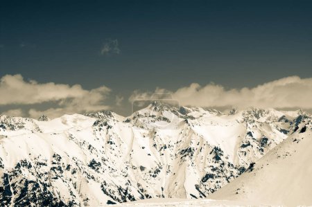 Foto de High winter snowy mountains. Caucasus Mountains, region Dombay. Retro color toned landscape. - Imagen libre de derechos