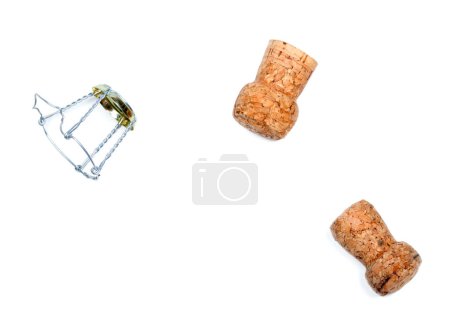 Foto de Two corks from champagne wine and muselet after party. Isolated on white background. - Imagen libre de derechos