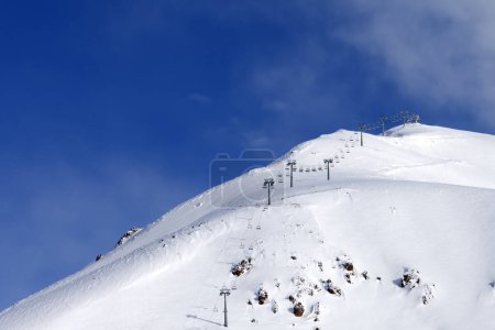 Photo for Snowy off-piste ski slope and ropeway at winter morning. Caucasus Mountains. Georgia, region Gudauri, Mount Sadzele. - Royalty Free Image