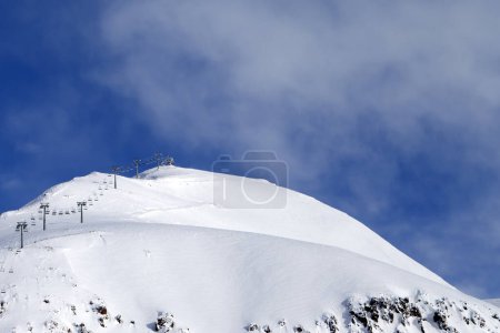 Photo for Snowy off-piste ski slope, ropeway and sky in fog at winter morning. Caucasus Mountains. Georgia, region Gudauri, Mount Sadzele. - Royalty Free Image