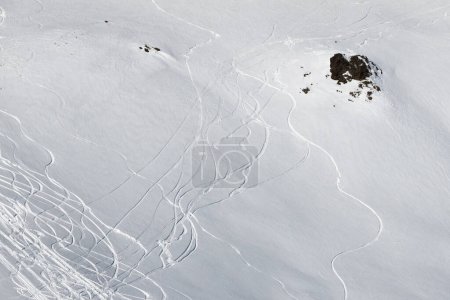 Photo for View on snowy off piste slope with traces of skis and snowboards at sunny winter day - Royalty Free Image
